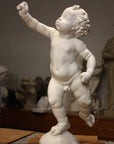 Photo of a sculpture of a cherub on a black background