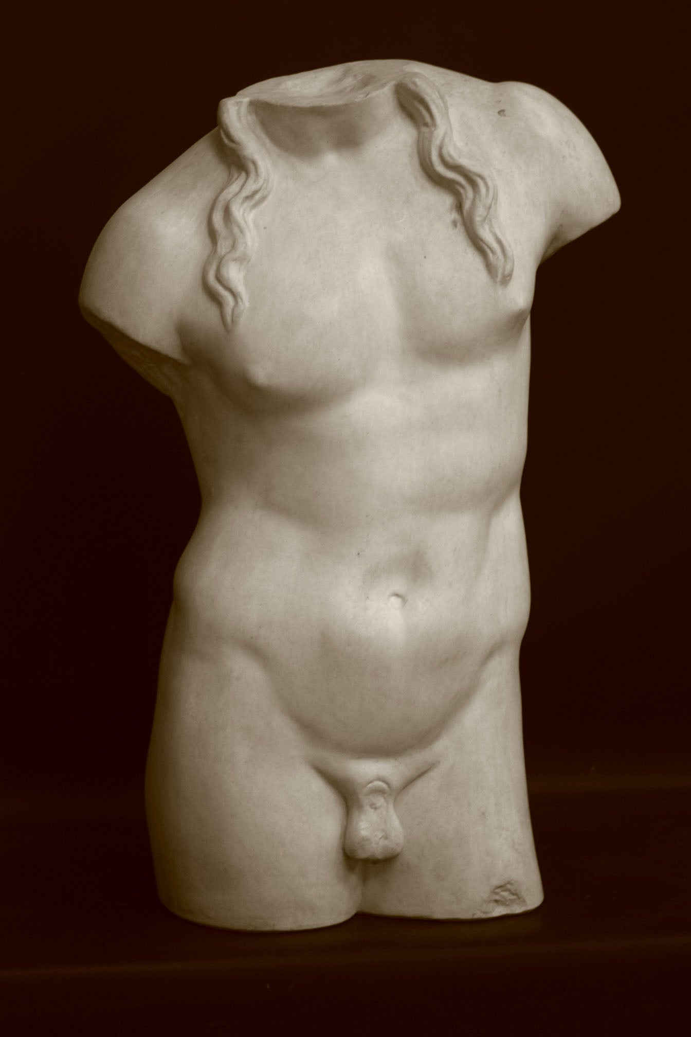 Photo of a decorative sculpture of a torso on a black background