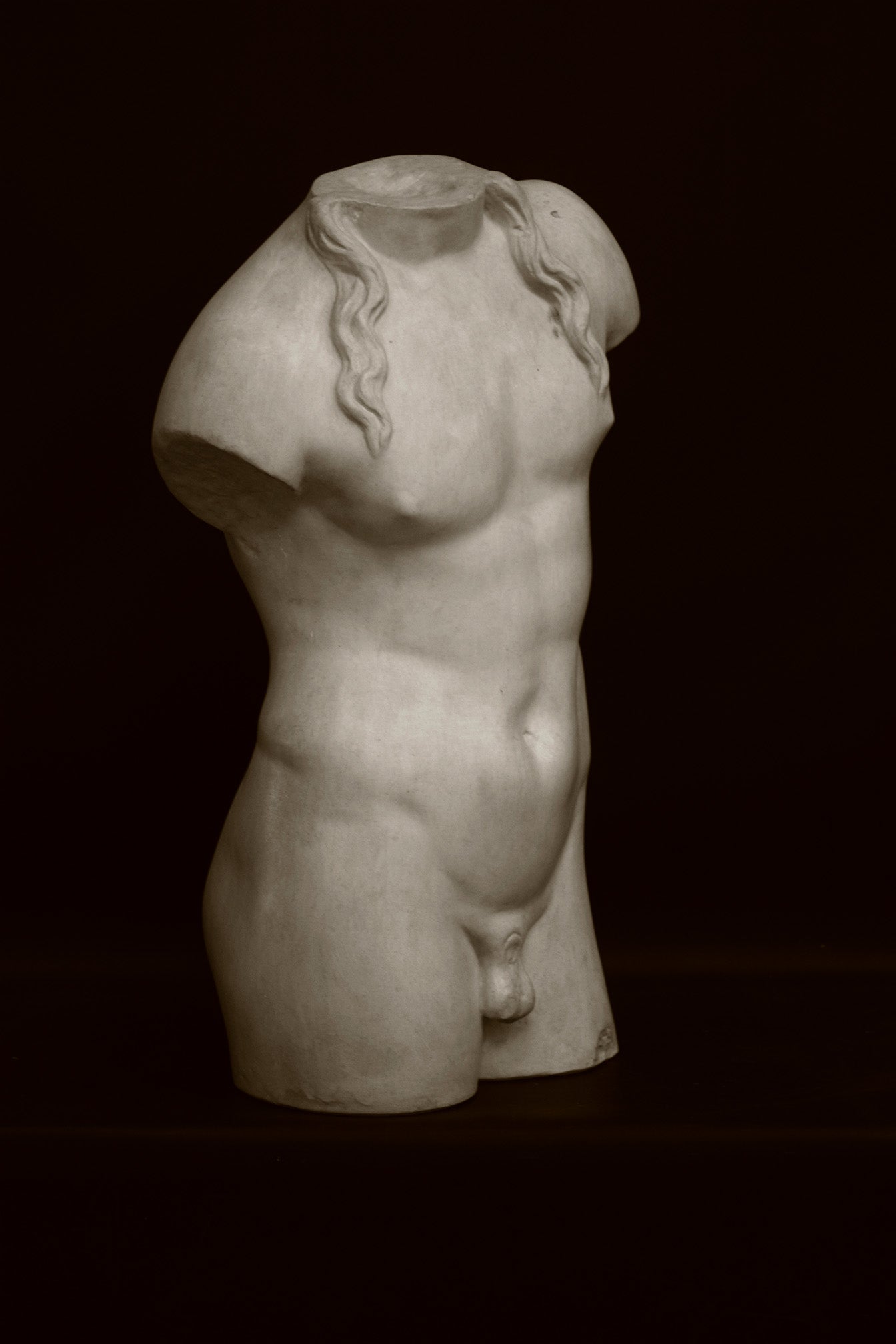 Photo of a decorative sculpture of a torso on a black background