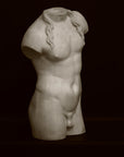 Photo of a decorative sculpture of a torso on a black background