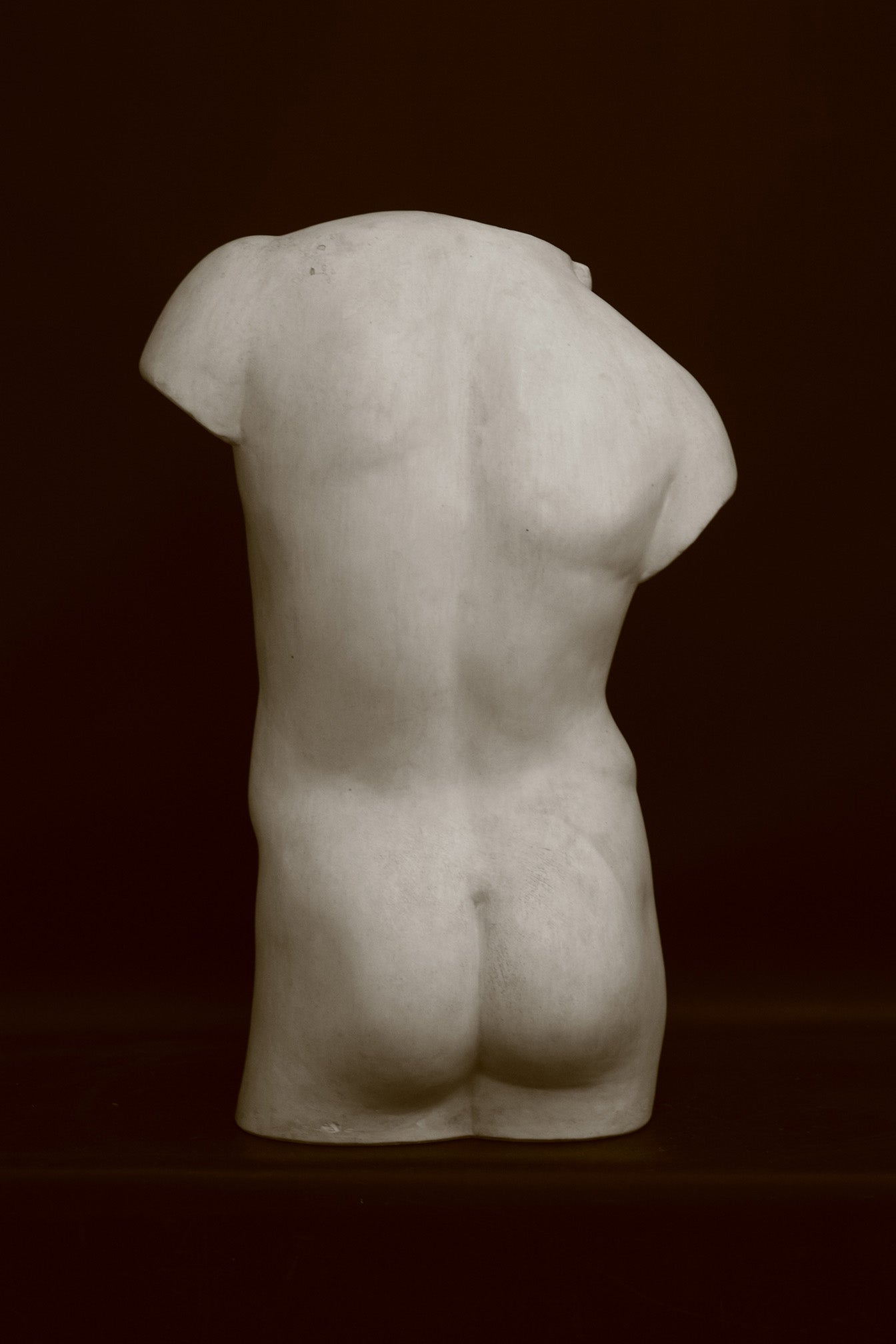 Photo of a decorative sculpture of a torso on a black background
