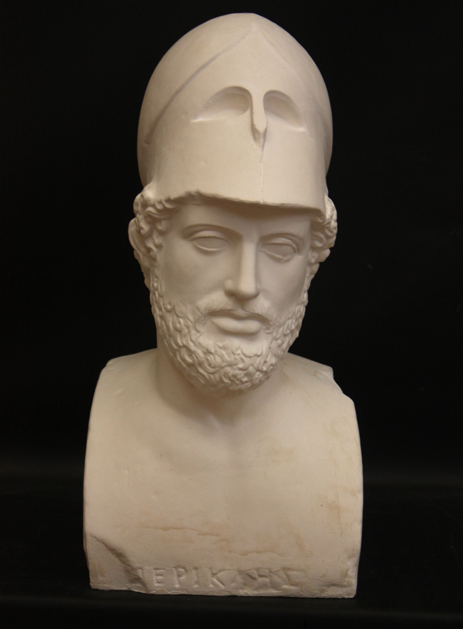 Photo of male sculpture with beard and helmet on a black background