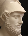 close-up photo of male sculpture with beard and helmet on a black background
