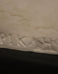 close up photo of a signature on a plaster sculpture
