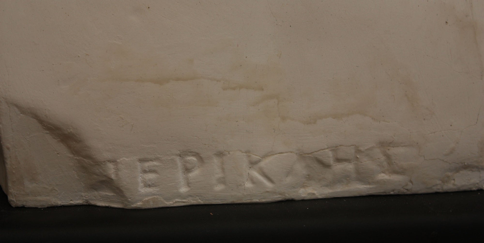 close up photo of a signature on a plaster sculpture