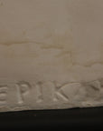 close up photo of a signature on a plaster sculpture