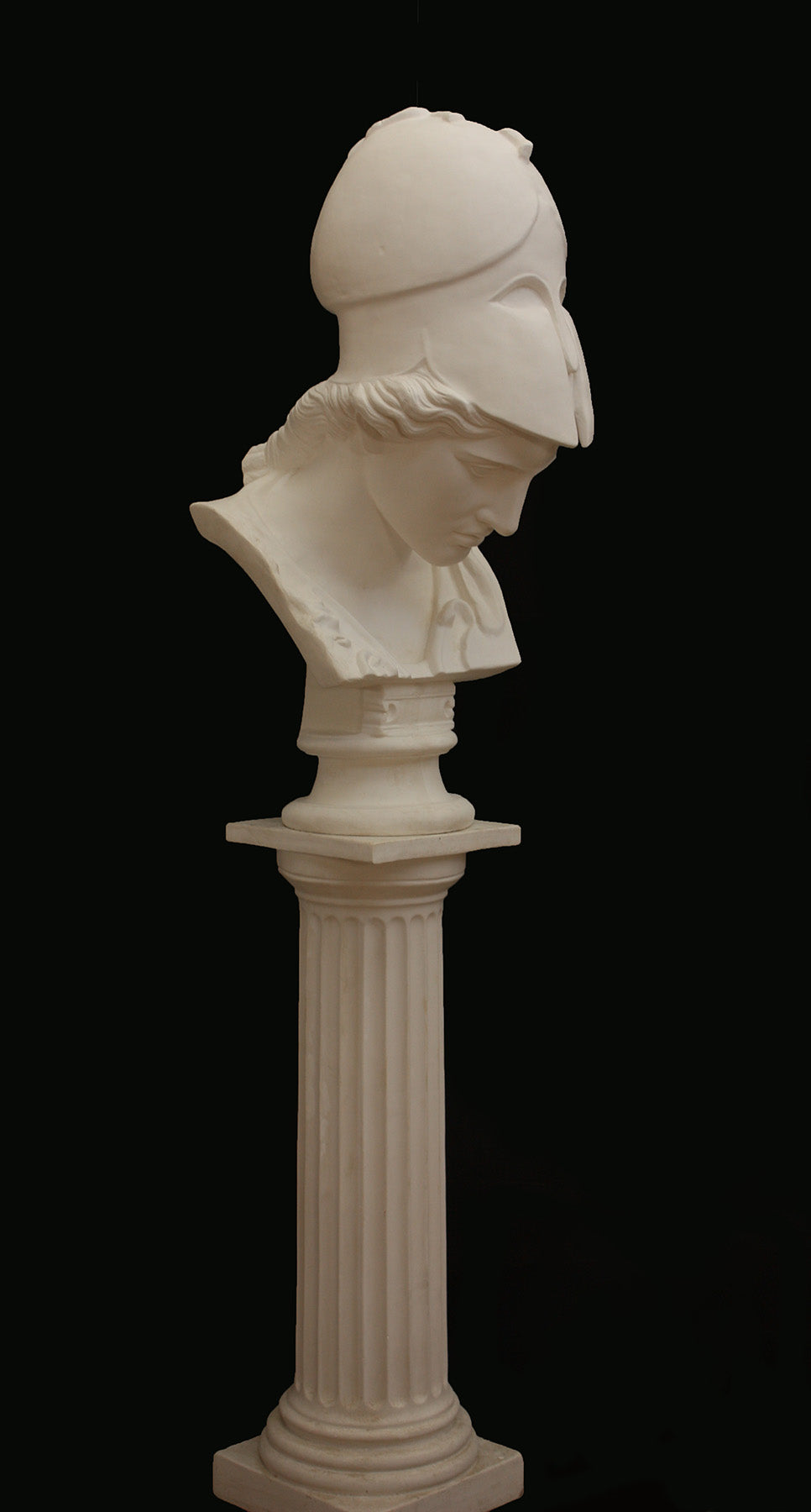 Image of a plaster statue pf a bust of Minerva on a black background