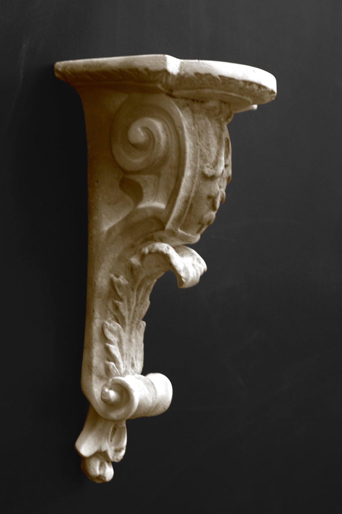 image of a plaster statue of a renaissance bracket on a gray background