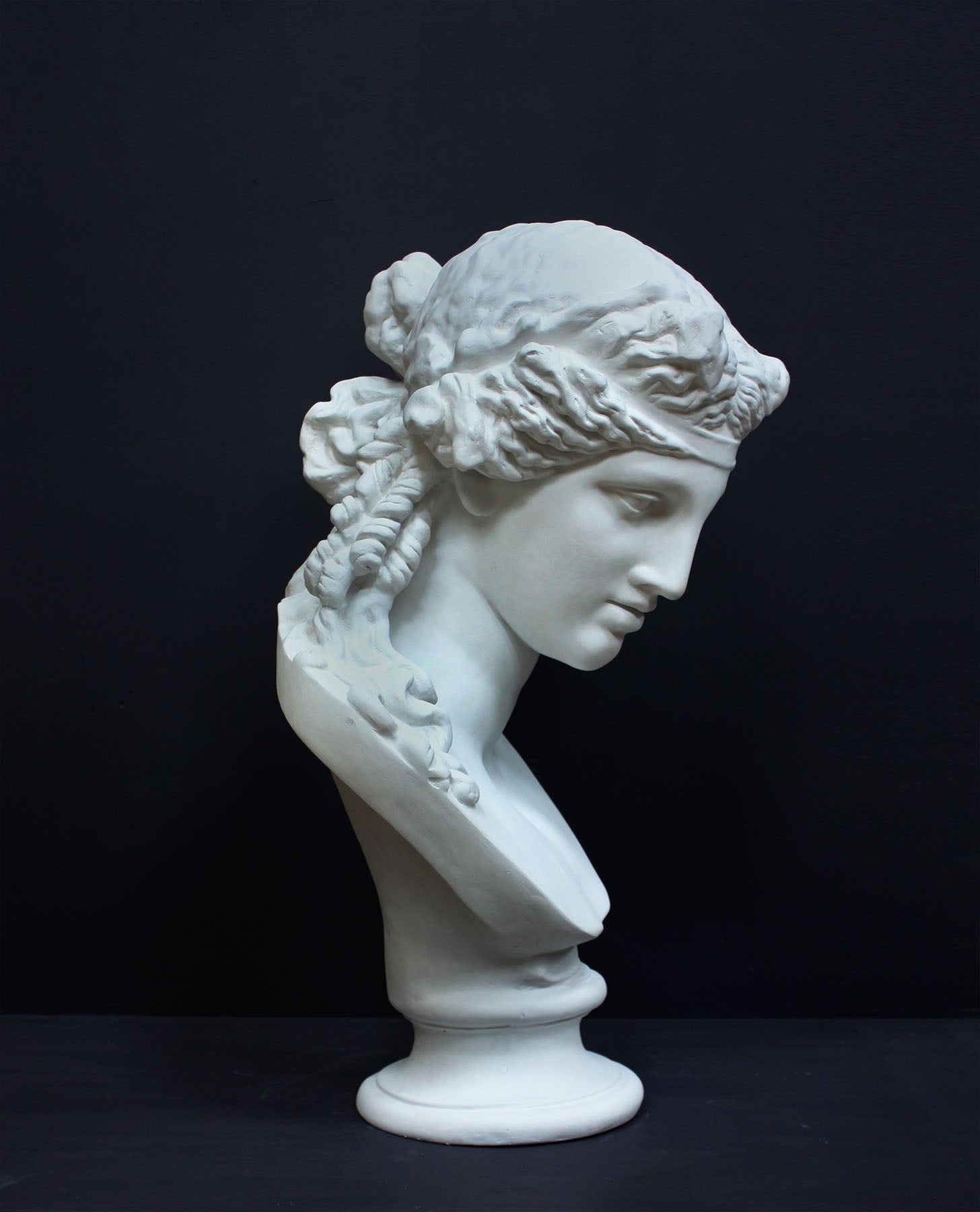 image of a plaster statue of a bust of ariadne on a gray background