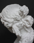 detail photo of plaster cast of sculpture bust of Ariadne or Bacchus with long, curly hair and head band on a gray background