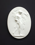 Image of a small plaster plaque of Hercules carrying a boar on a black background
