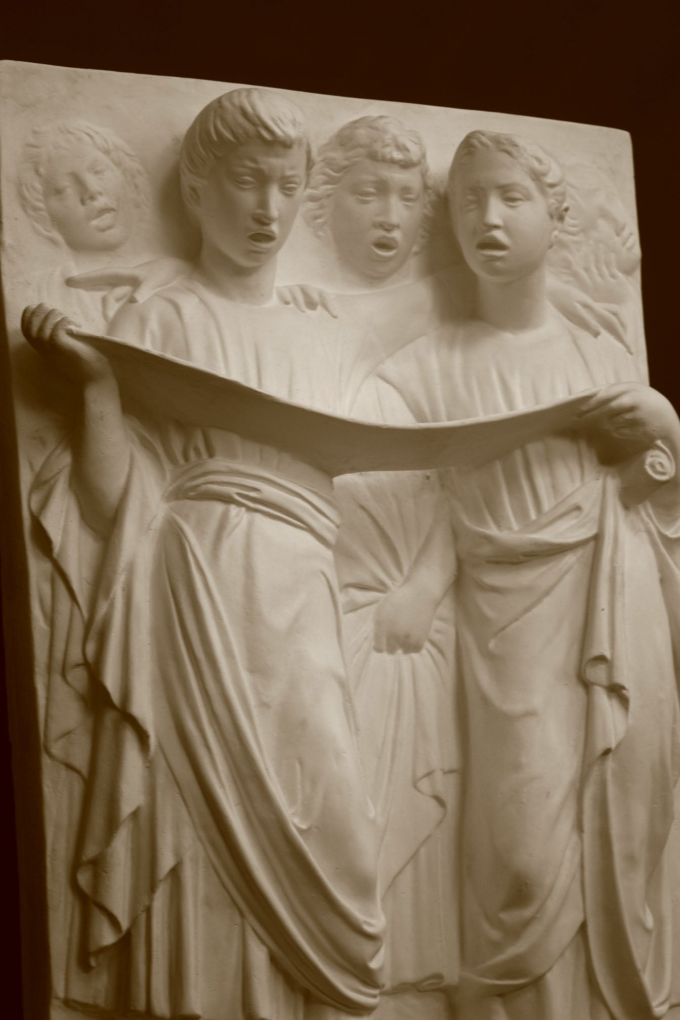 Photo of a sculpture of Cantoria Singers on a black background