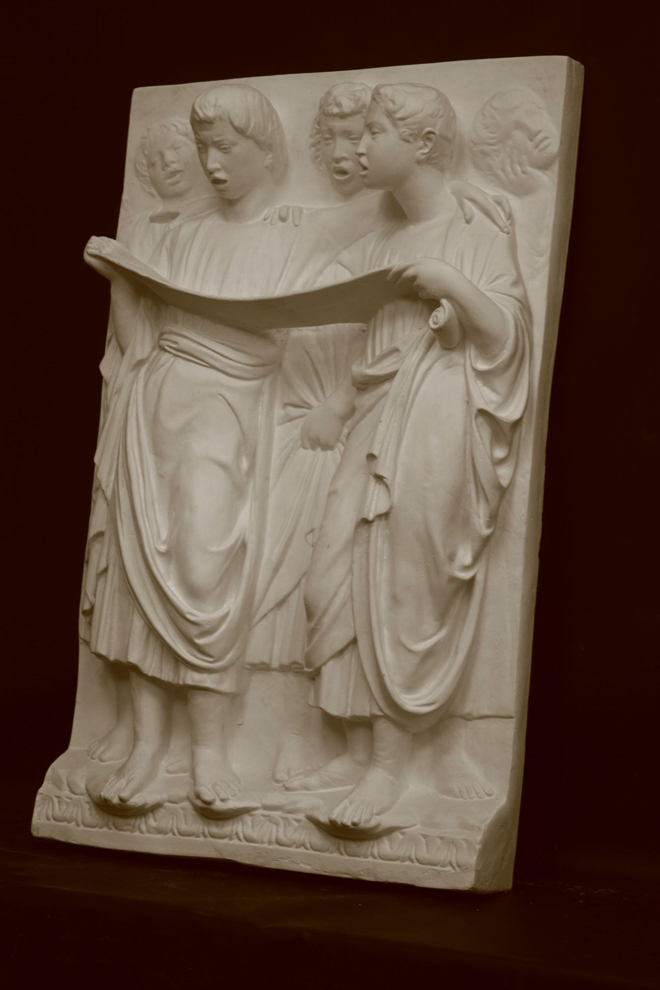 Photo of a sculpture of Cantoria Singers on a black background