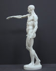 photo of plaster cast sculpture of flayed male figure study with right arm outstretched and left arm down on a gray background