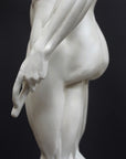photo of plaster cast sculpture of flayed male figure study with right arm outstretched and left arm down on a gray background
