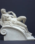 photo of a sculpture of a reclining nude female on a grey background