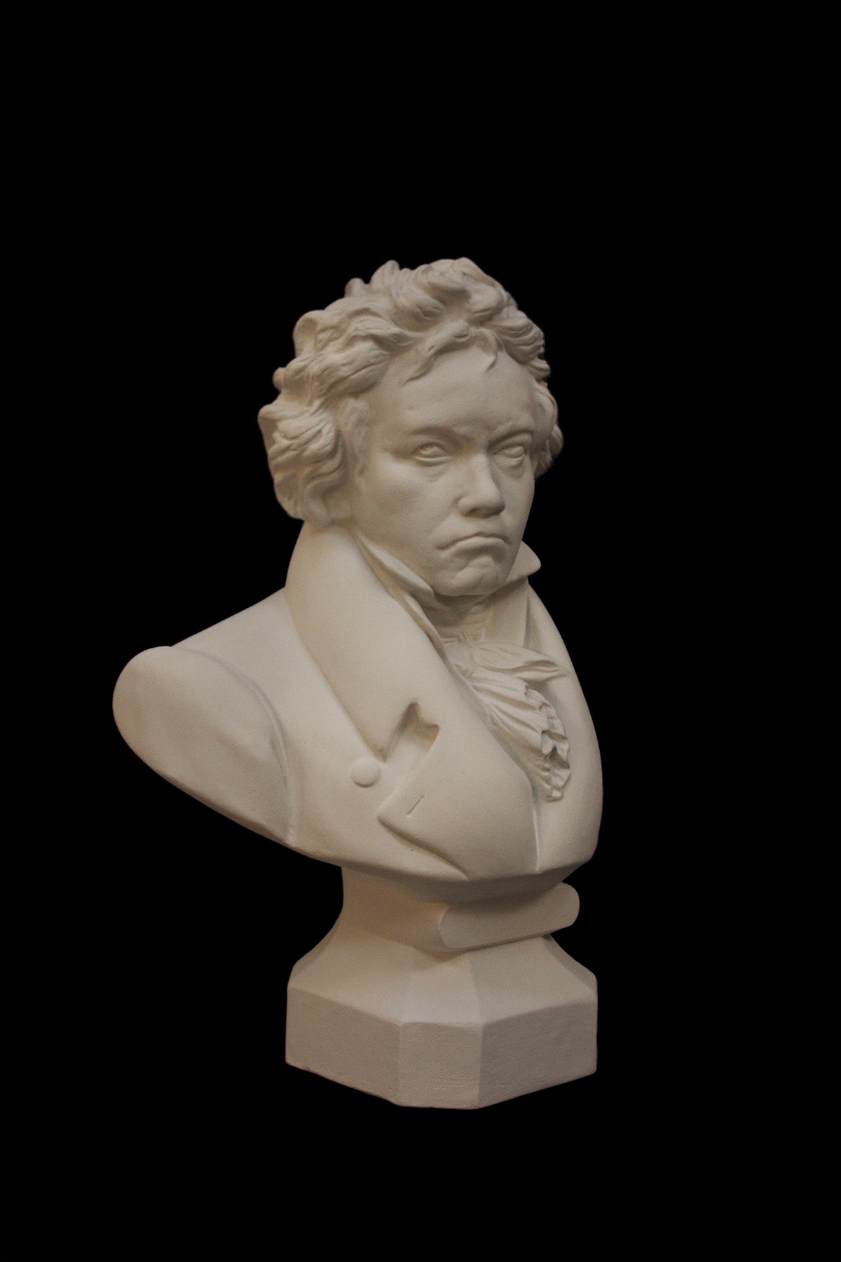 image of a plaster statue of a bust of Beethoven on a black background