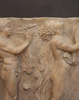 Photo of sculpture of 2 figures marching with musical instruments on a black background