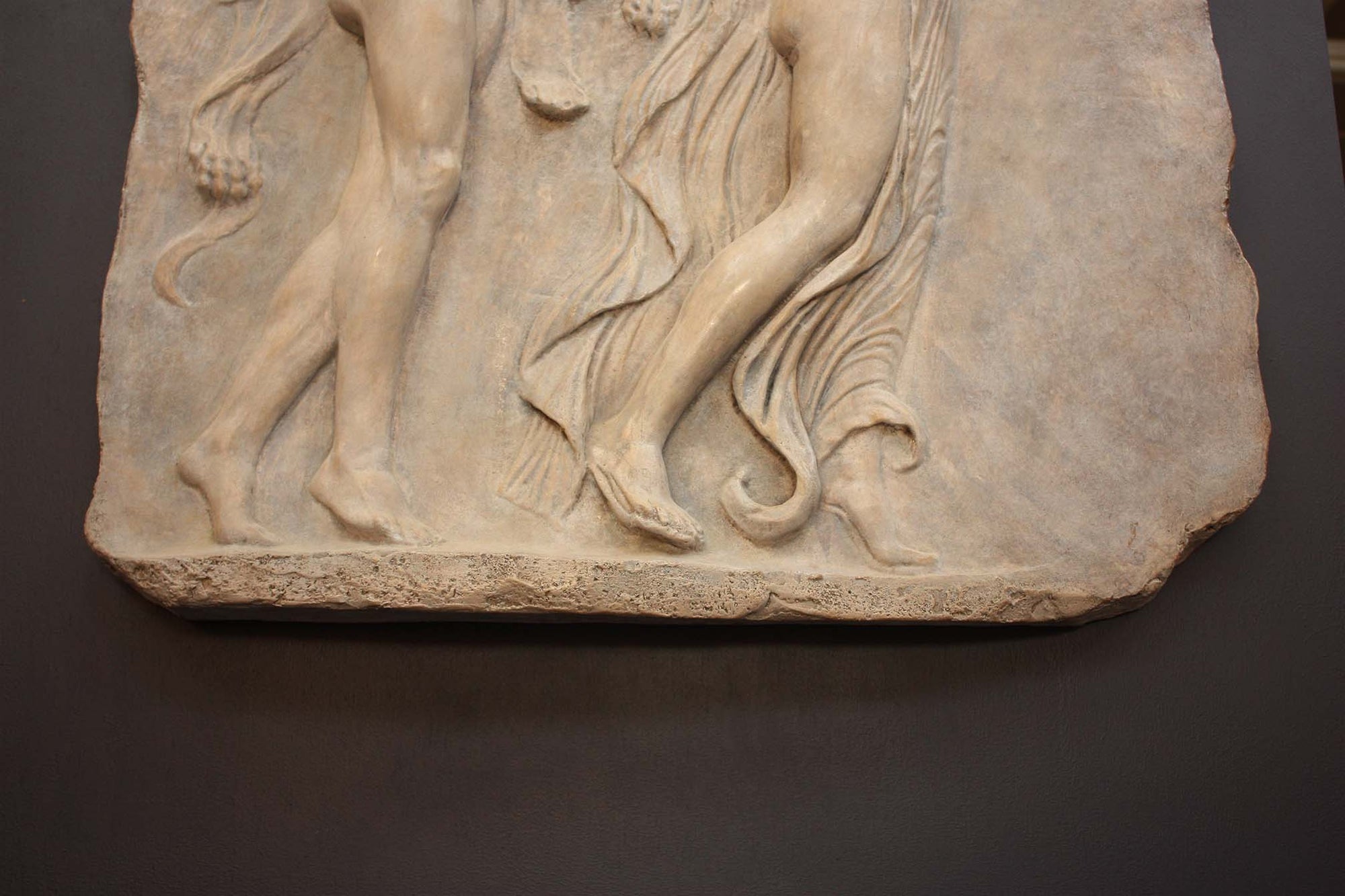 detail of Photo of sculpture of 2 figures marching with musical instruments on a black background