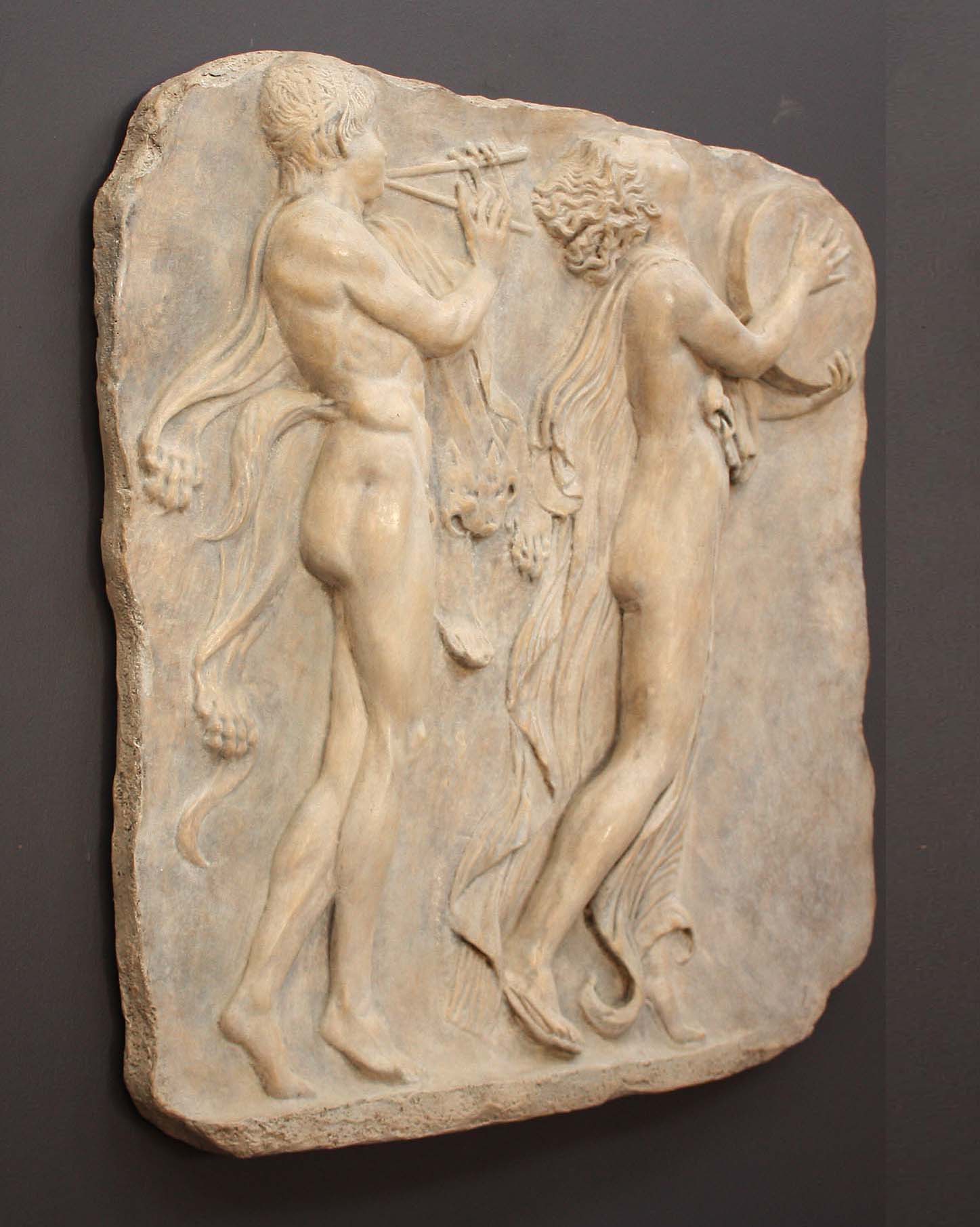 Photo of sculpture of 2 figures marching with musical instruments on a black background
