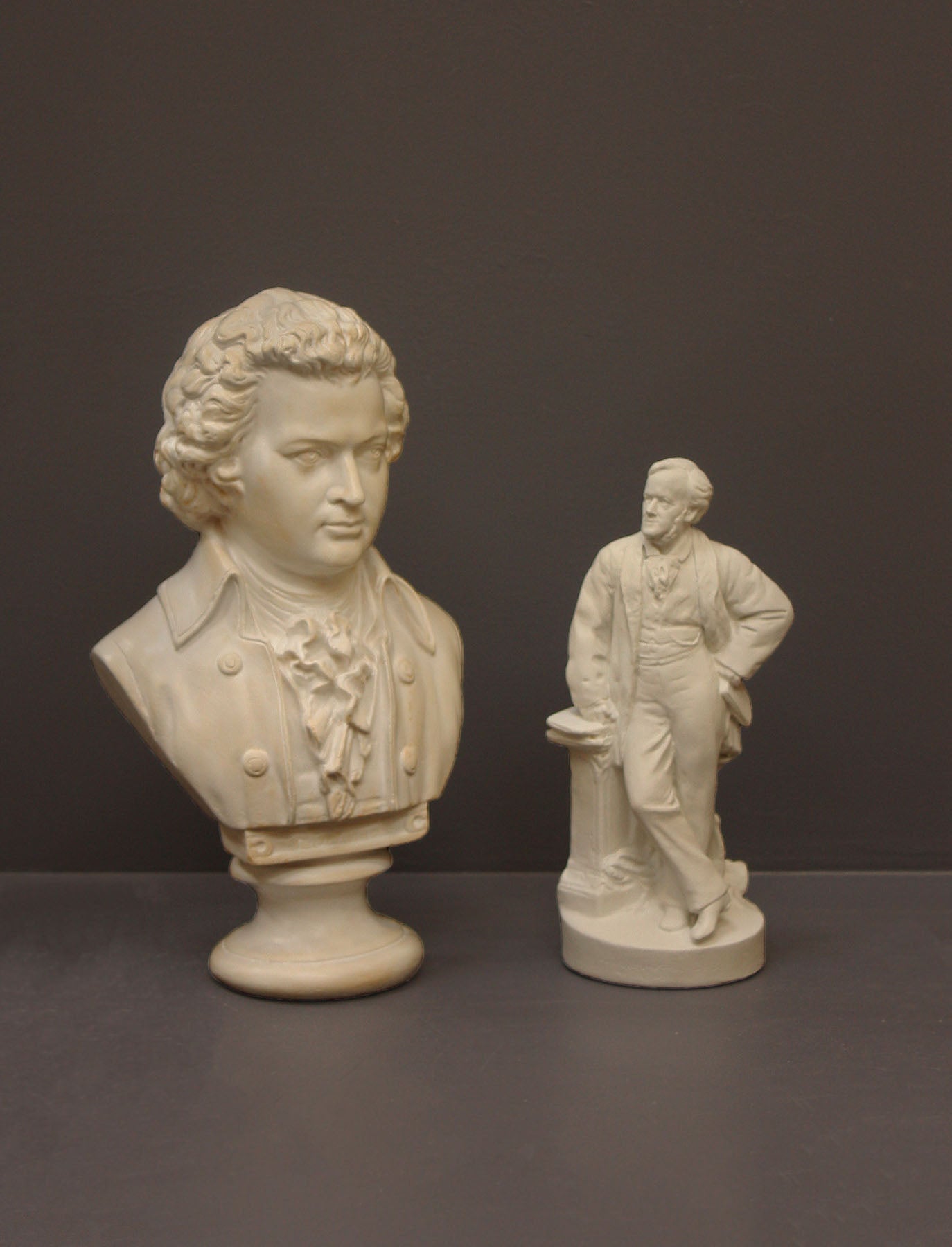 image of a plaster statue of a bust of wagner and mozart on a gray background
