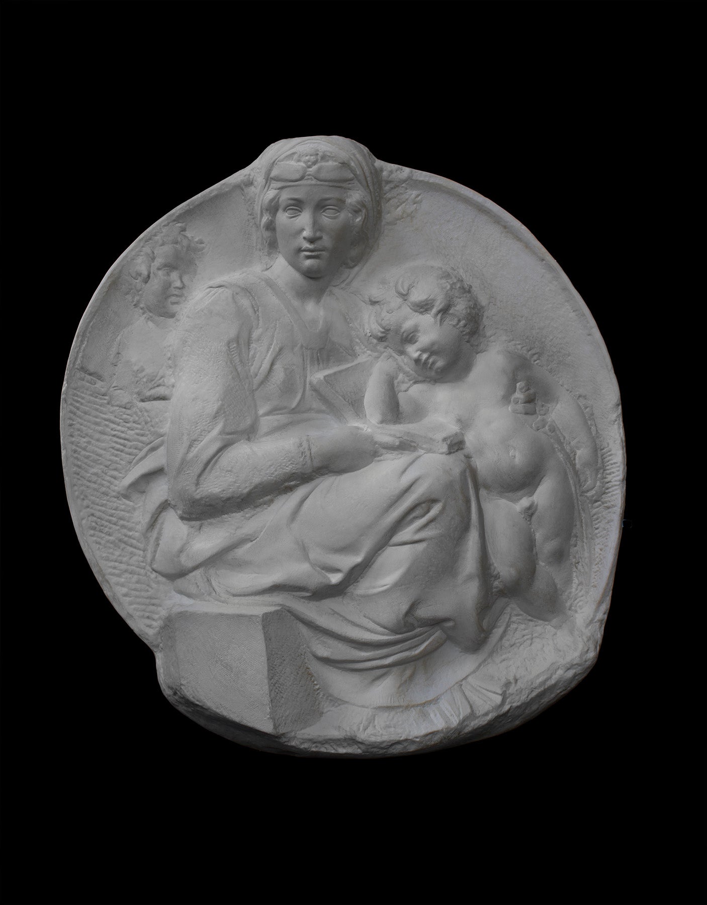 image of a plaster statue of a bust of madonna and child on a black background