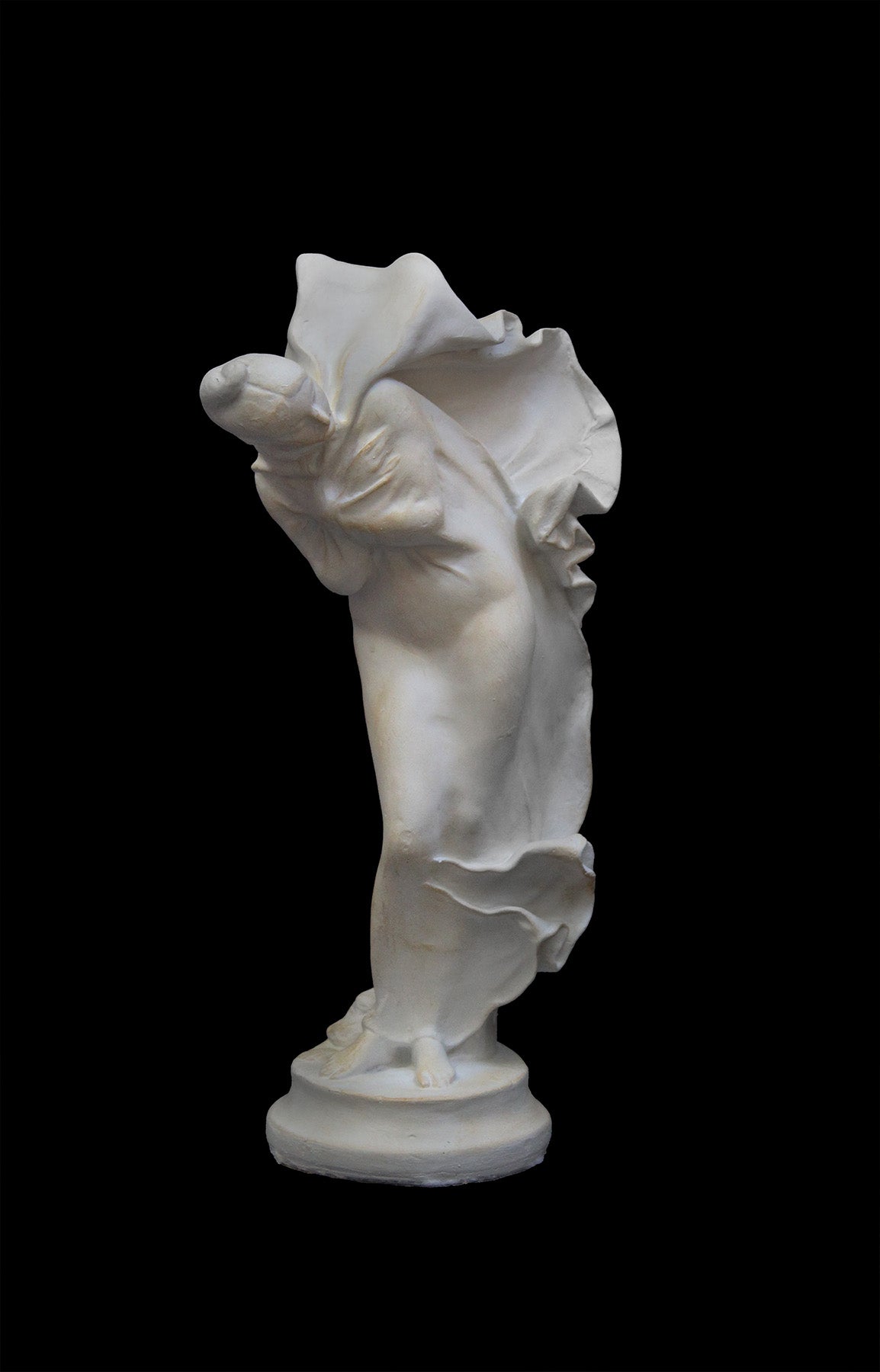 image of a plaster statue of a bust of dancer on a black background
