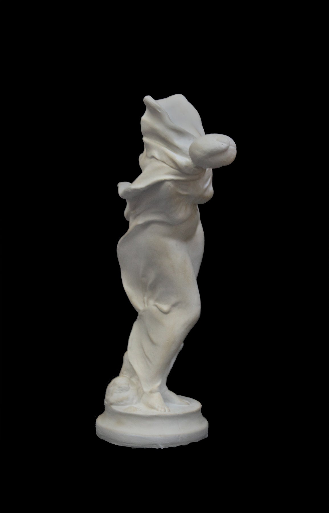 image of a plaster statue of a bust of dancer on a black background