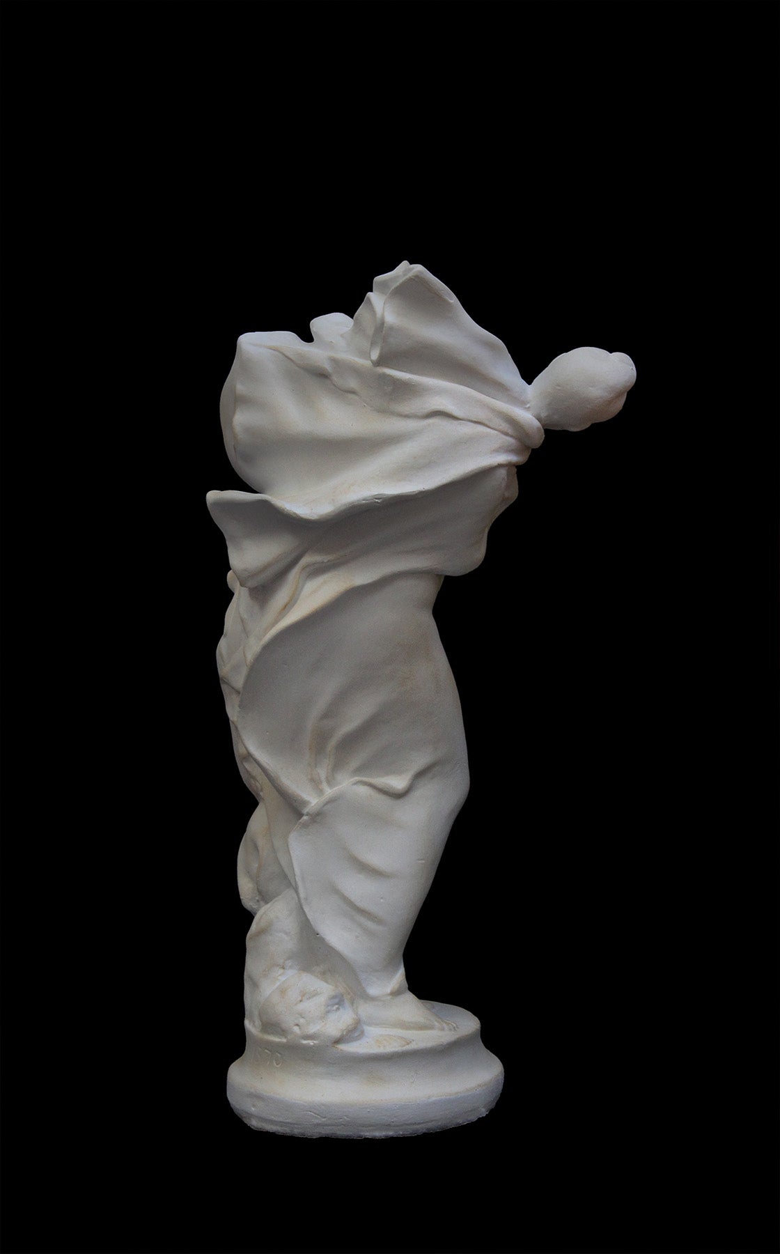 image of a plaster statue of a bust of dancer on a black background