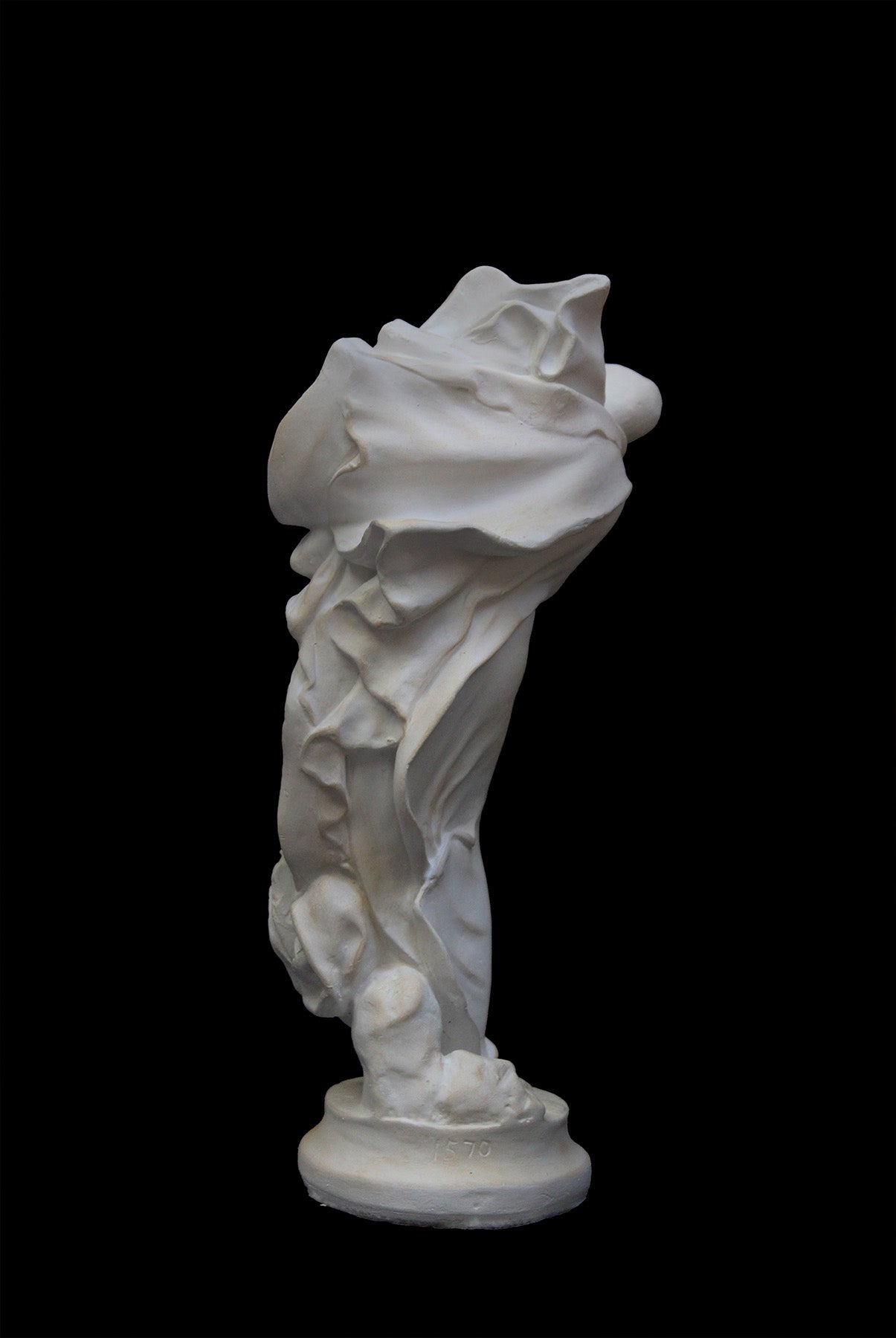 image of a plaster statue of a bust of dancer on a black background