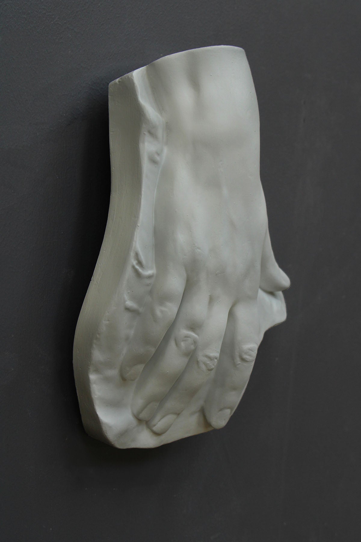 Photo of a plaster hand on a black background