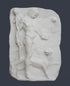 photo of white plaster cast relief sculpture of satyr with animal skin over his arm and staff in one hand walking beside a panther against gray background