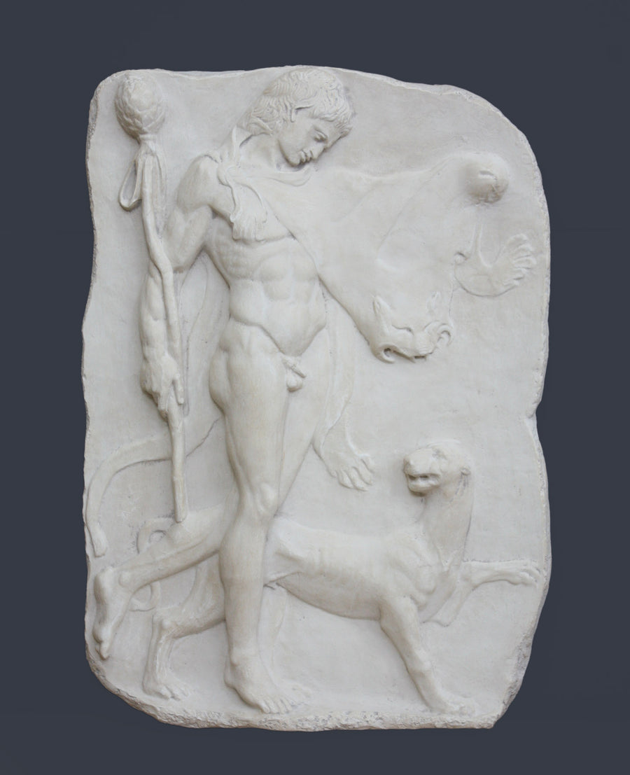 photo of white plaster cast relief sculpture of satyr with animal skin over his arm and staff in one hand walking beside a panther against gray background