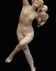 photo with black background of plaster cast sculpture of nude female dancing with left leg raised and right arm raised and hand holding grapes, and holding a baby in left arm