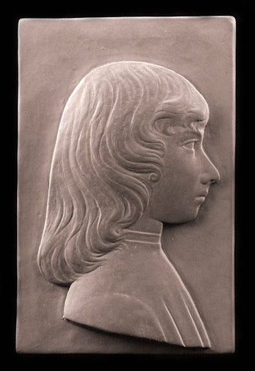 tinted photo of plaster cast relief sculpture of young female in profile with long hair on a black background