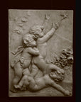 photo with black background of plaster cast relief sculpture of three cupids, two close together chasing a butterfly and one on ground