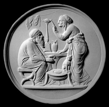 black and white photo of white plaster cast relief sculpture of elderly male and female figures at a table and a cat against black background