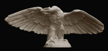 photo on black background of plaster cast sculpture of eagle with wings spread and head turned to its right