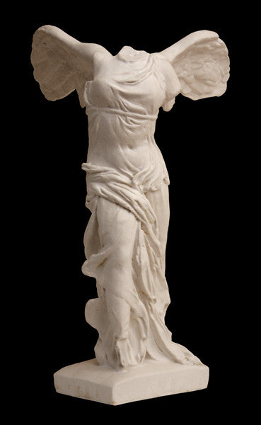 photo of plaster cast sculpture of winged, headless female figure with flowing drapery on a black background