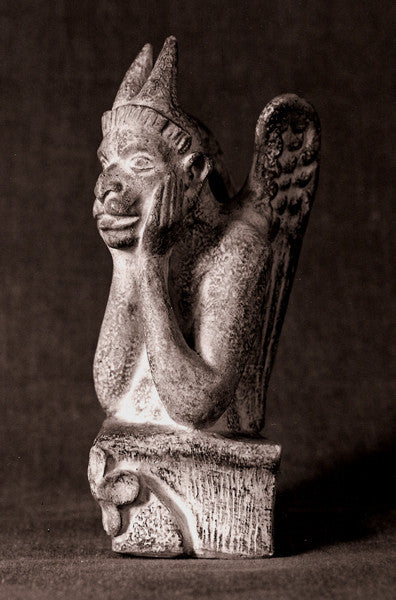 black and white photo of plaster cast sculpture of Le Stryge, an architectural feature from Notre-Dame Cathedral, a creature made of several animal body parts called a grotesque