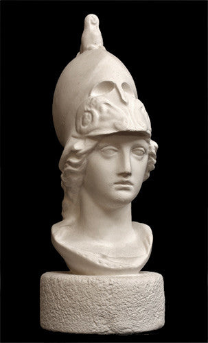 photo of plaster cast sculpture bust of female head, namely the goddess Athena, with a helmet on a black background