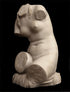 photo with black background of plaster cast sculpture of female torso seated
