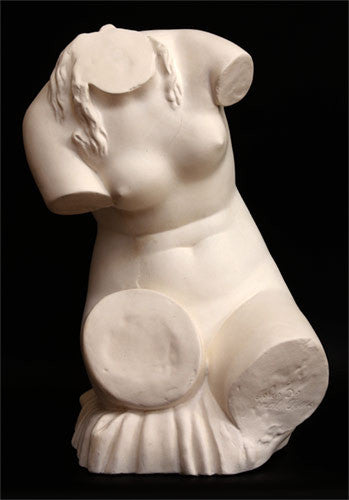 photo with black background of plaster cast sculpture of female torso seated