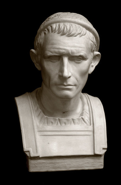 photo with black background of plaster cast bust sculpture of a man, namely Antiochus III, with headband and clothing on the square bust