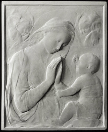 photo of plaster cast sculpture relief of the Madonna praying and looking at the baby Jesus and angels in the background