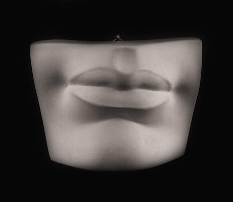 Photo plaster cast of a mouth from a sculpture's head on a black background