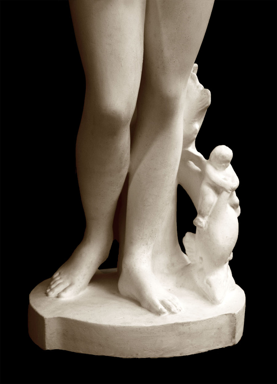 photo detail of plaster cast sculpture of Venus standing nude with two putti riding a dolphin at her feet