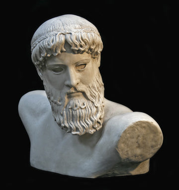 Photo with black background of plaster cast sculpture of male bust, namely the god Poseidon, with curly hair and beard and fragmented arms raised