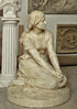 photo of plaster cast sculpture of Joan of Arc kneeling with hands on lap in a gallery with other plaster casts