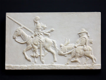 photo of plaster cast relief sculpture of two men riding horse and donkey all in profile with black background